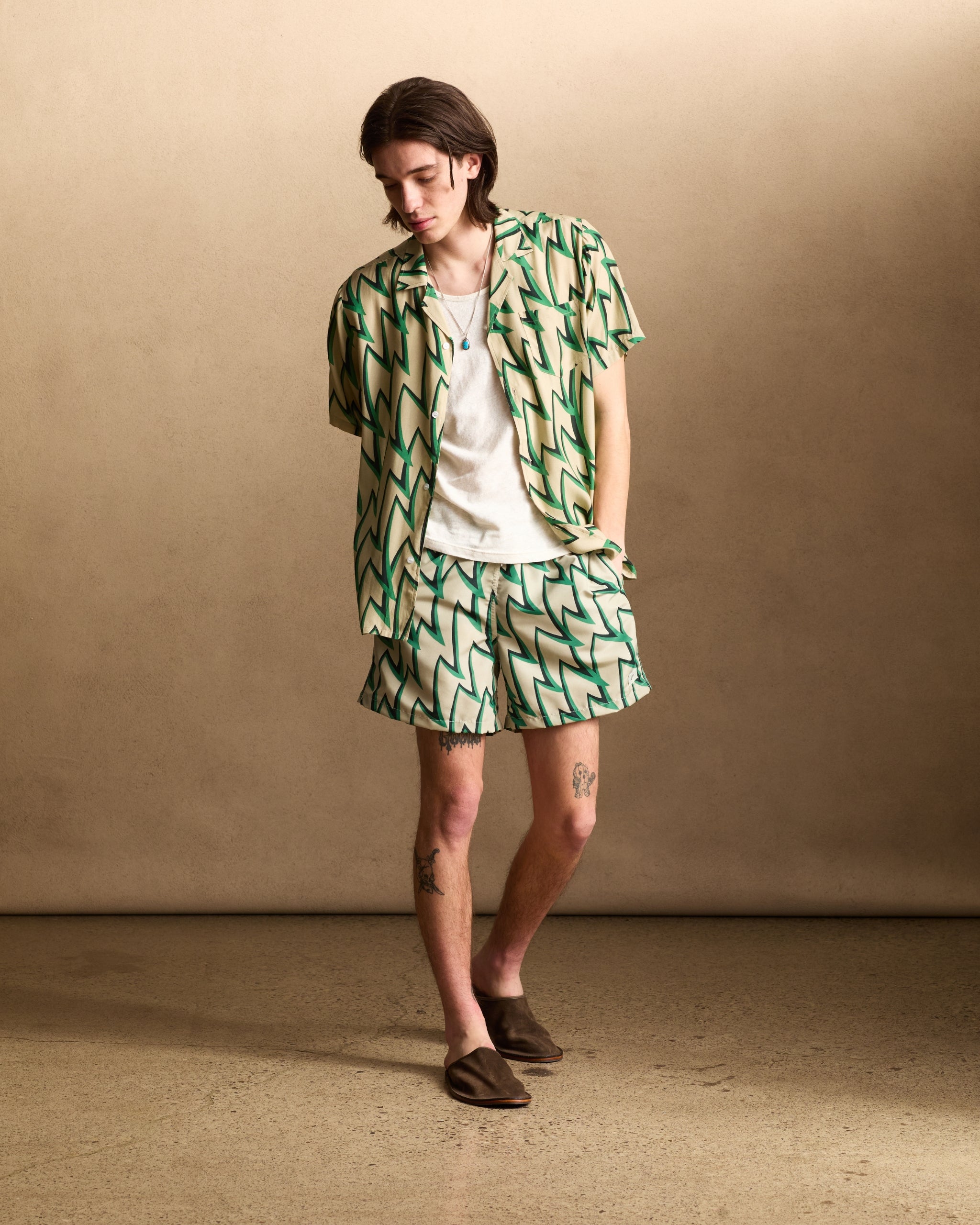 Light brown, green, and black Rayon Jagged Frenzy Camp Shirt shot on model
