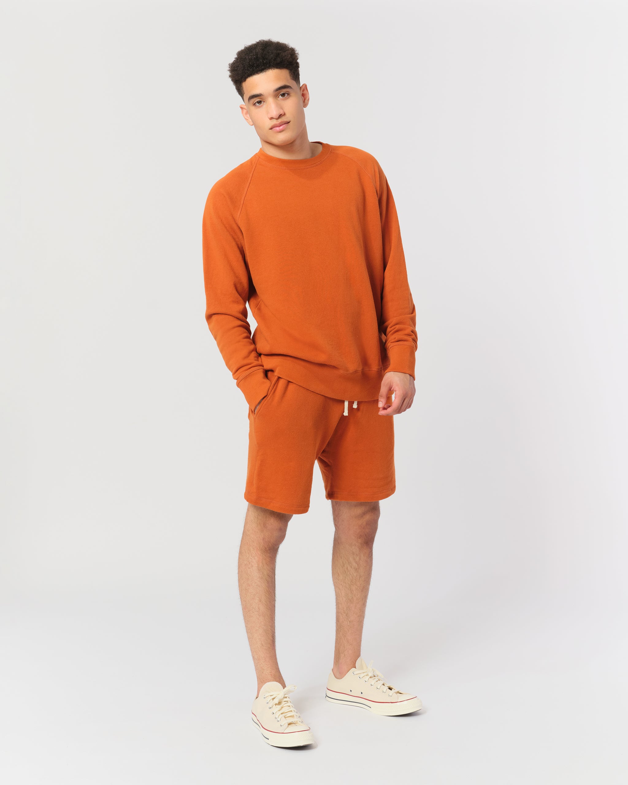 Orange french terry raglan sleeve crewneck sweatshirt shot on model