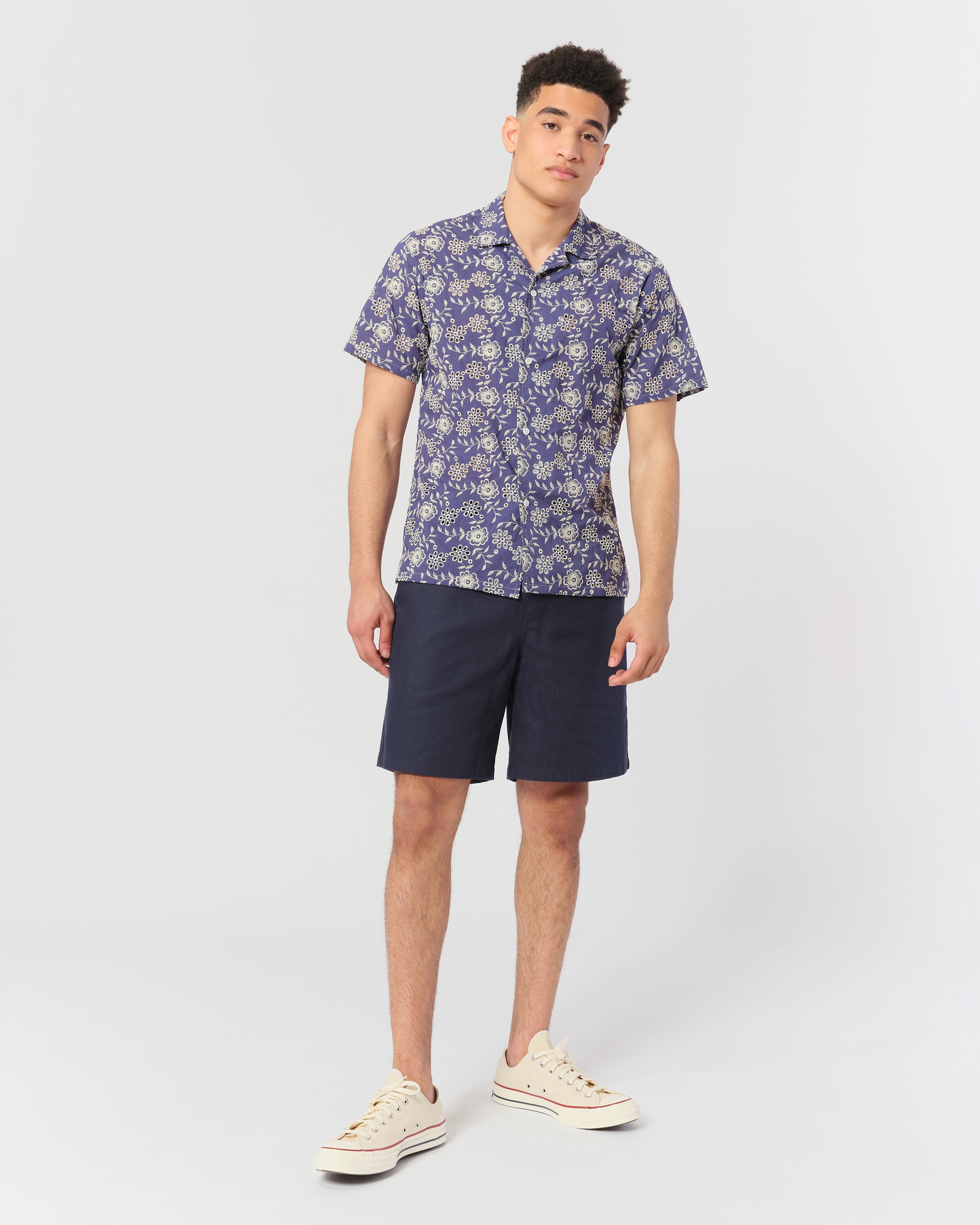 Blue camp shirt with an embroidered floral pattern shot on model