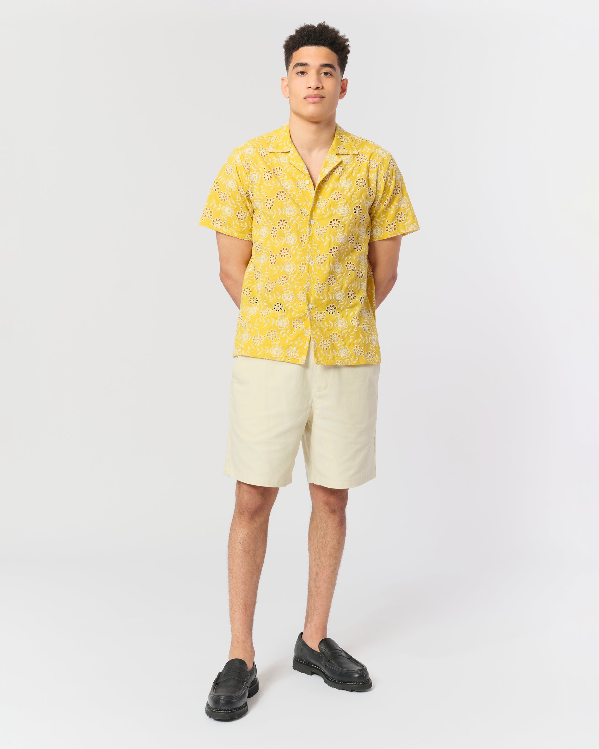 Yellow camp shirt with an embroidered floral pattern shot on model