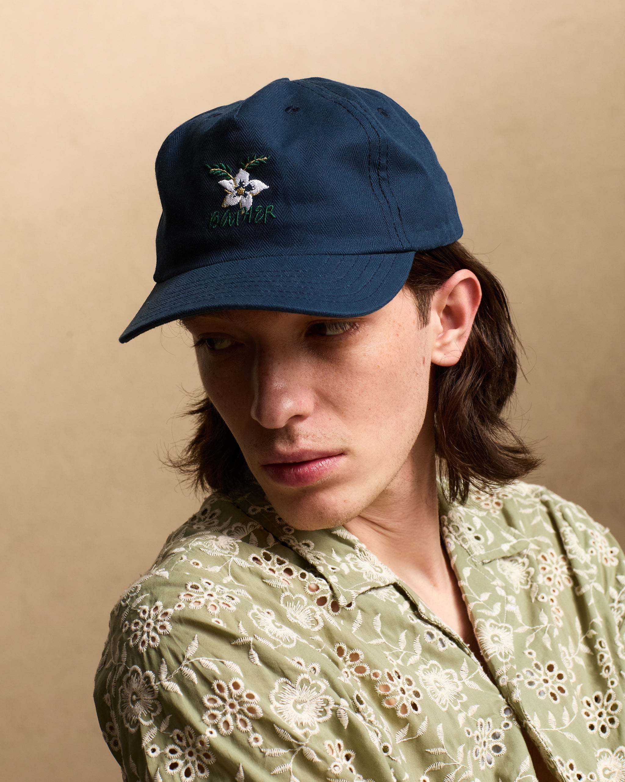 Navy Herringbone 5 Panel Cap with floral embroidered pattern shot on model
