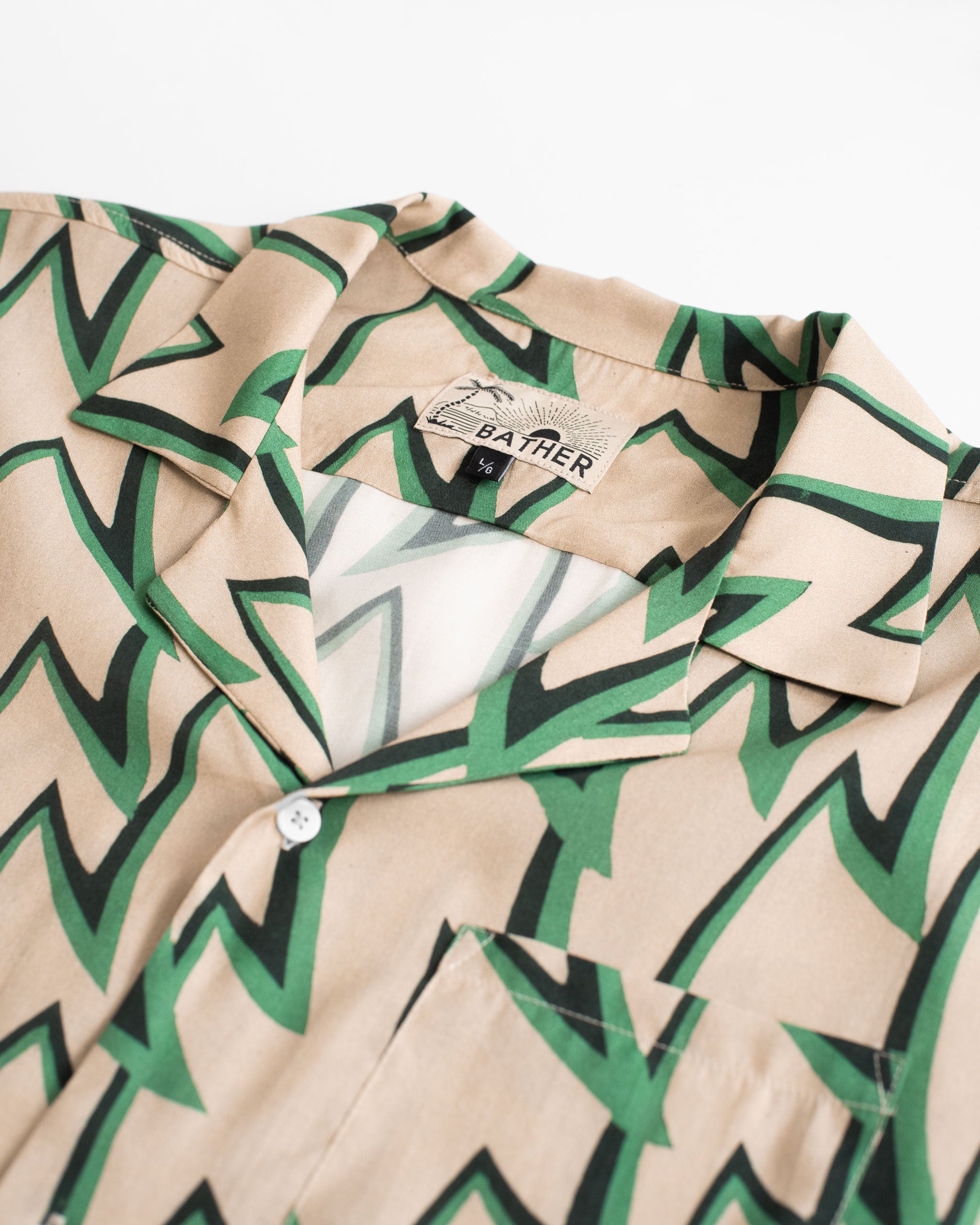 Collar close up of Light brown, green, and black Rayon Jagged Frenzy Camp Shirt