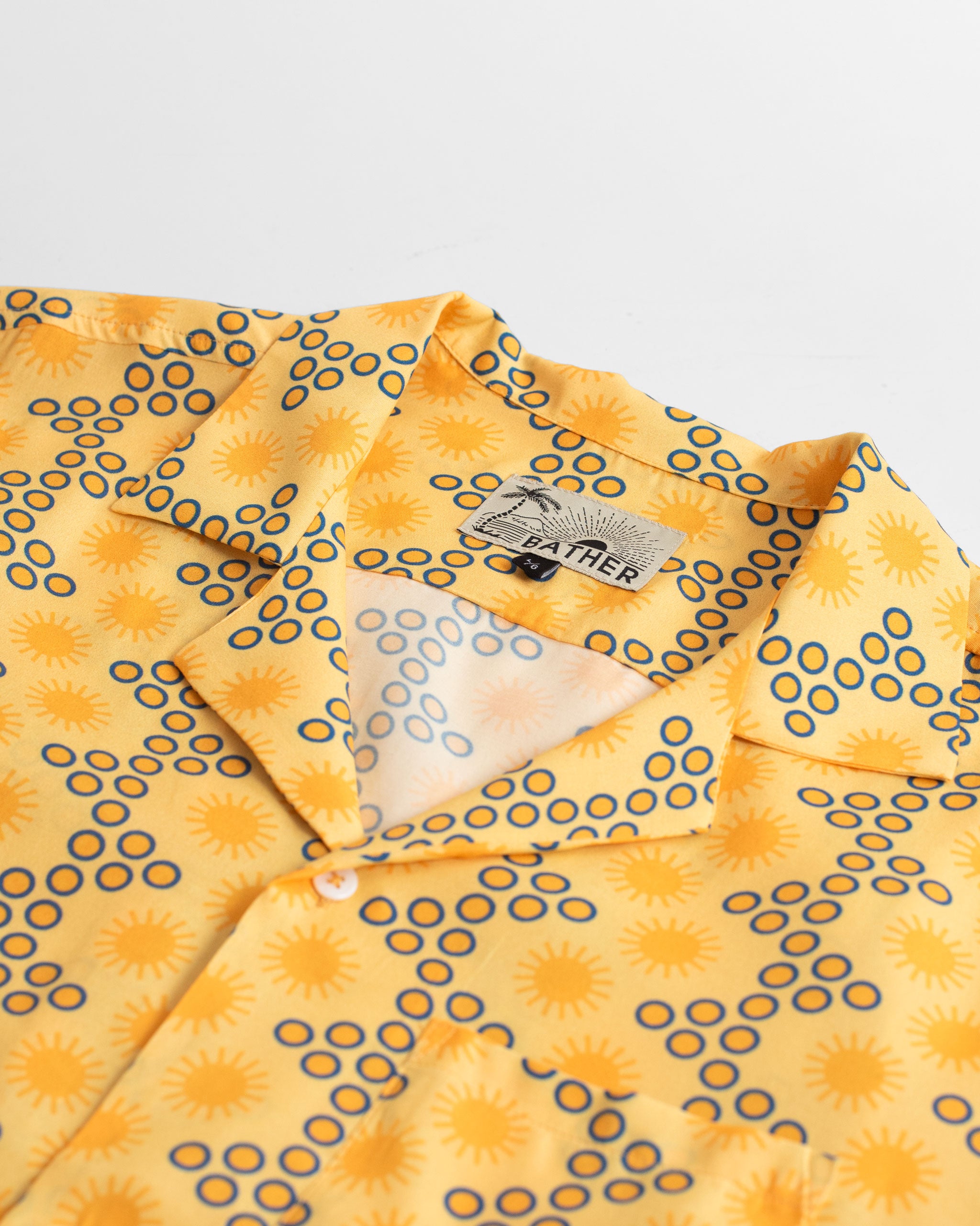 Collar close up shot of Yellow Disco Sun Graphic Rayon Camp Shirt