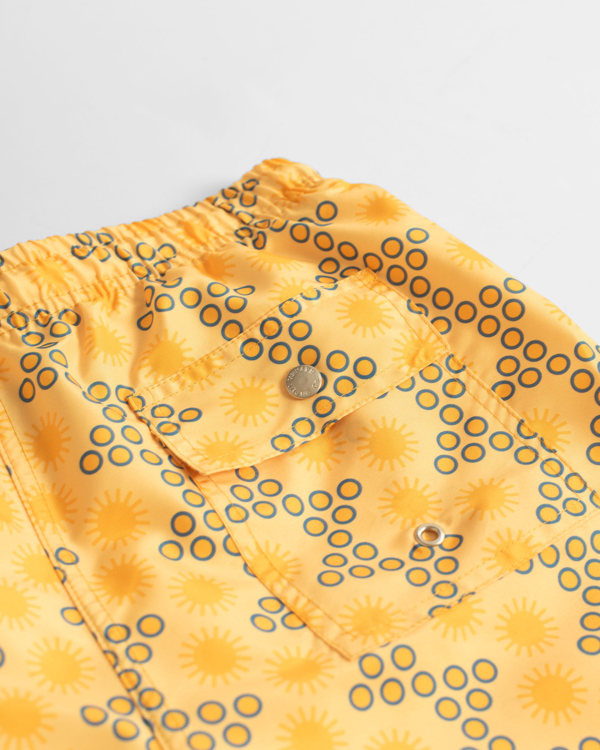Back Pocket Close Up of Yellow Disco Sun Graphic Swim Trunks