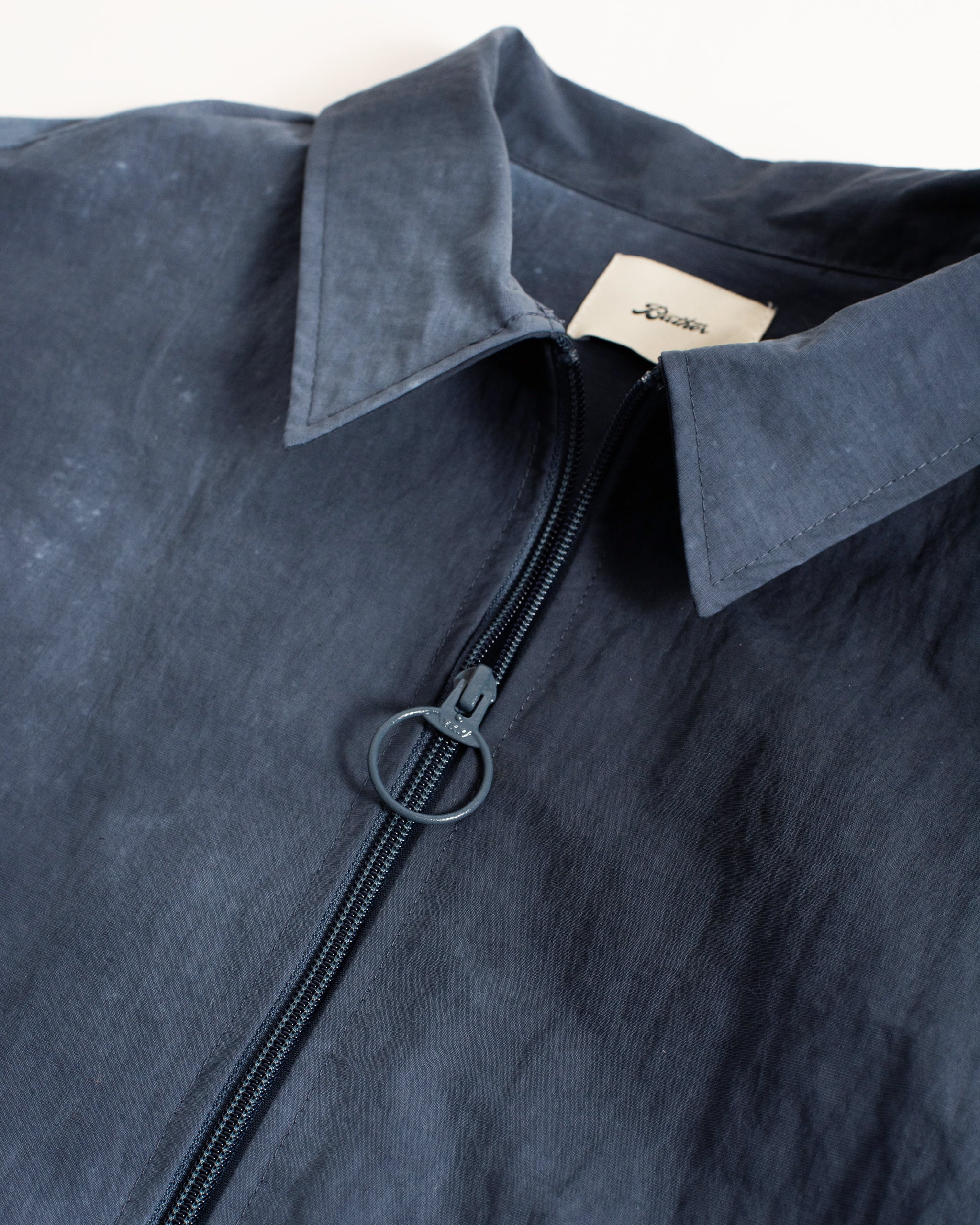 Bather blue zip polo on white background