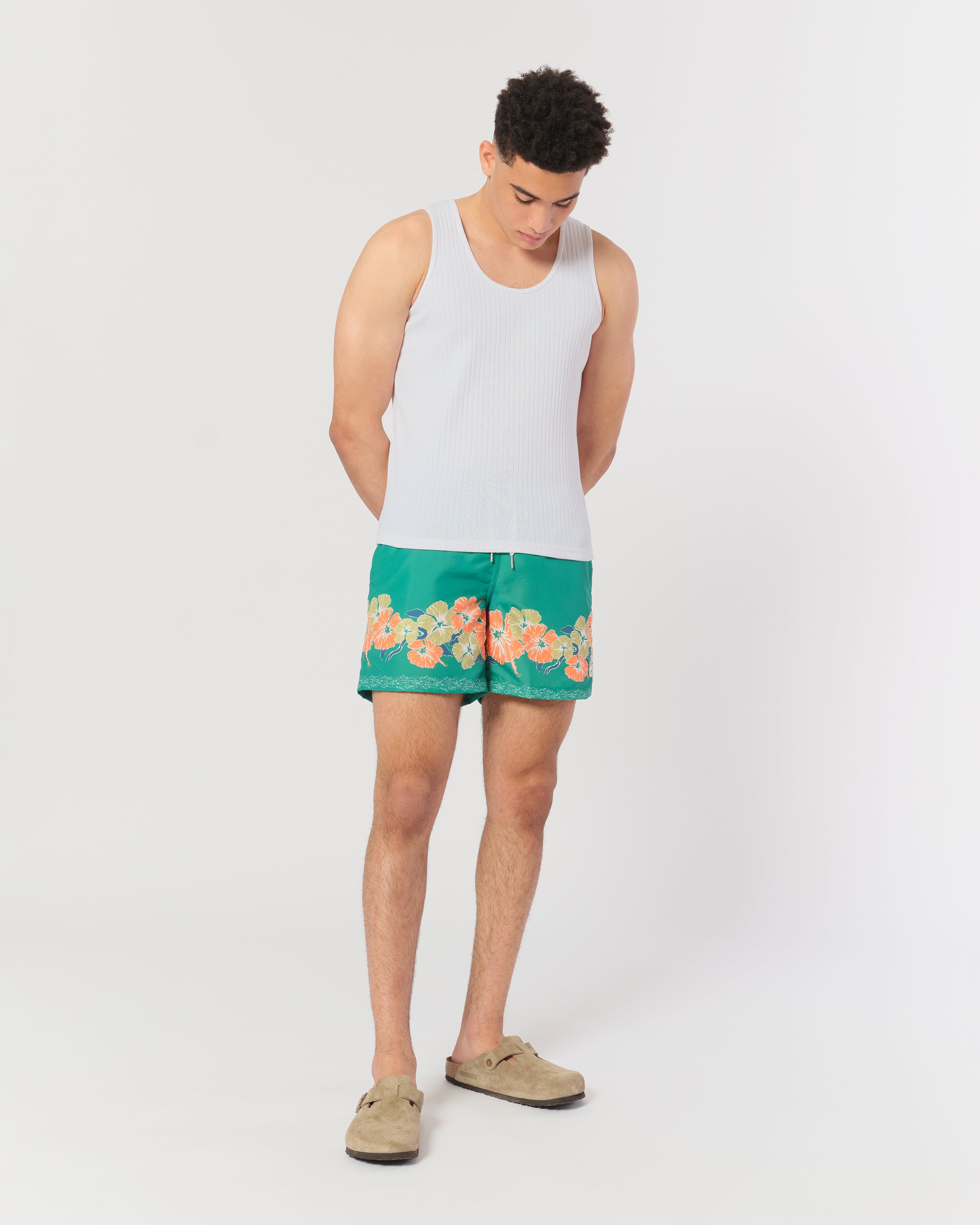 Green swim trunk with floral motif pattern on the bottom of the leg Shot on Model
