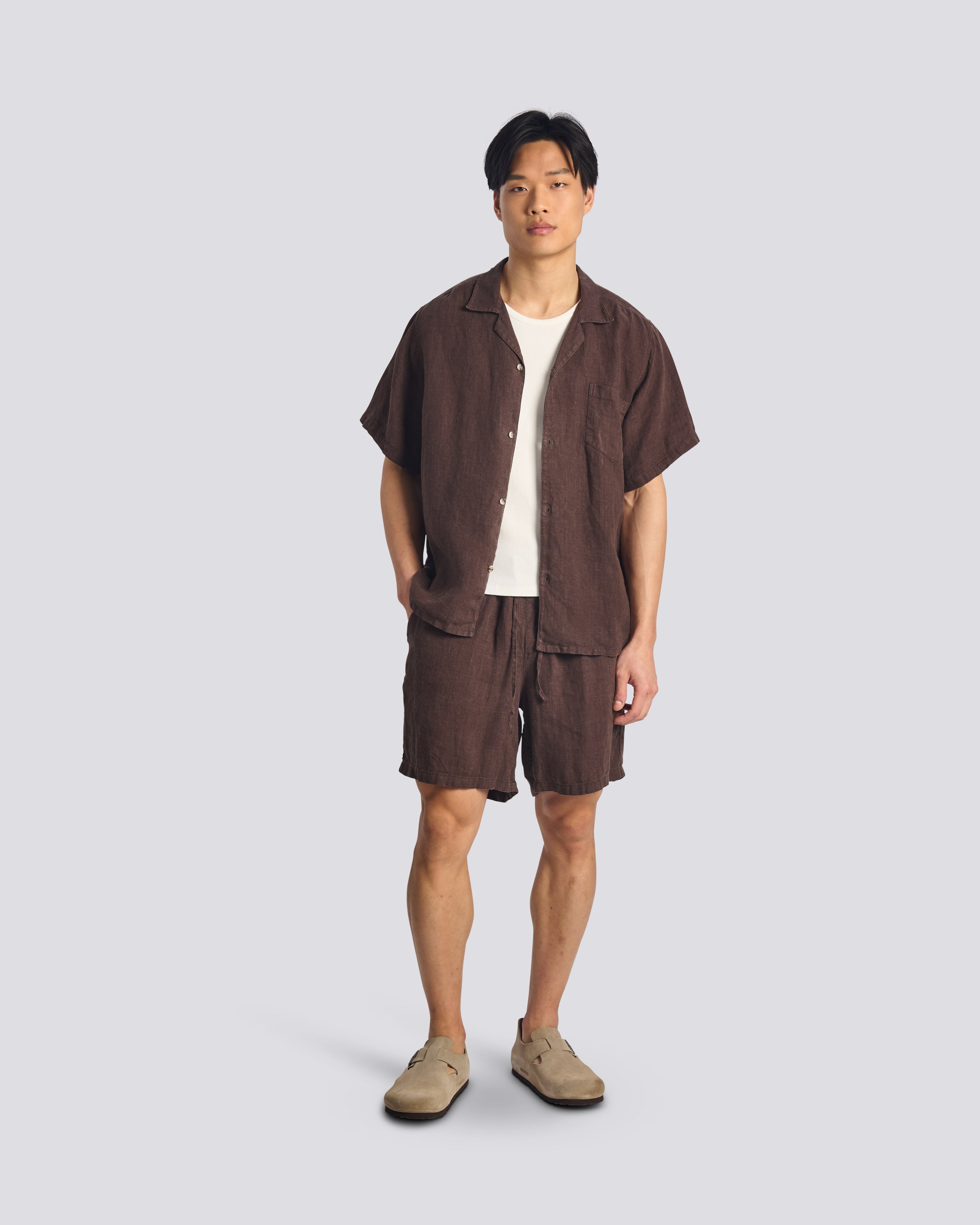 Model wearing Bather men's dark brown linen drawstring shorts