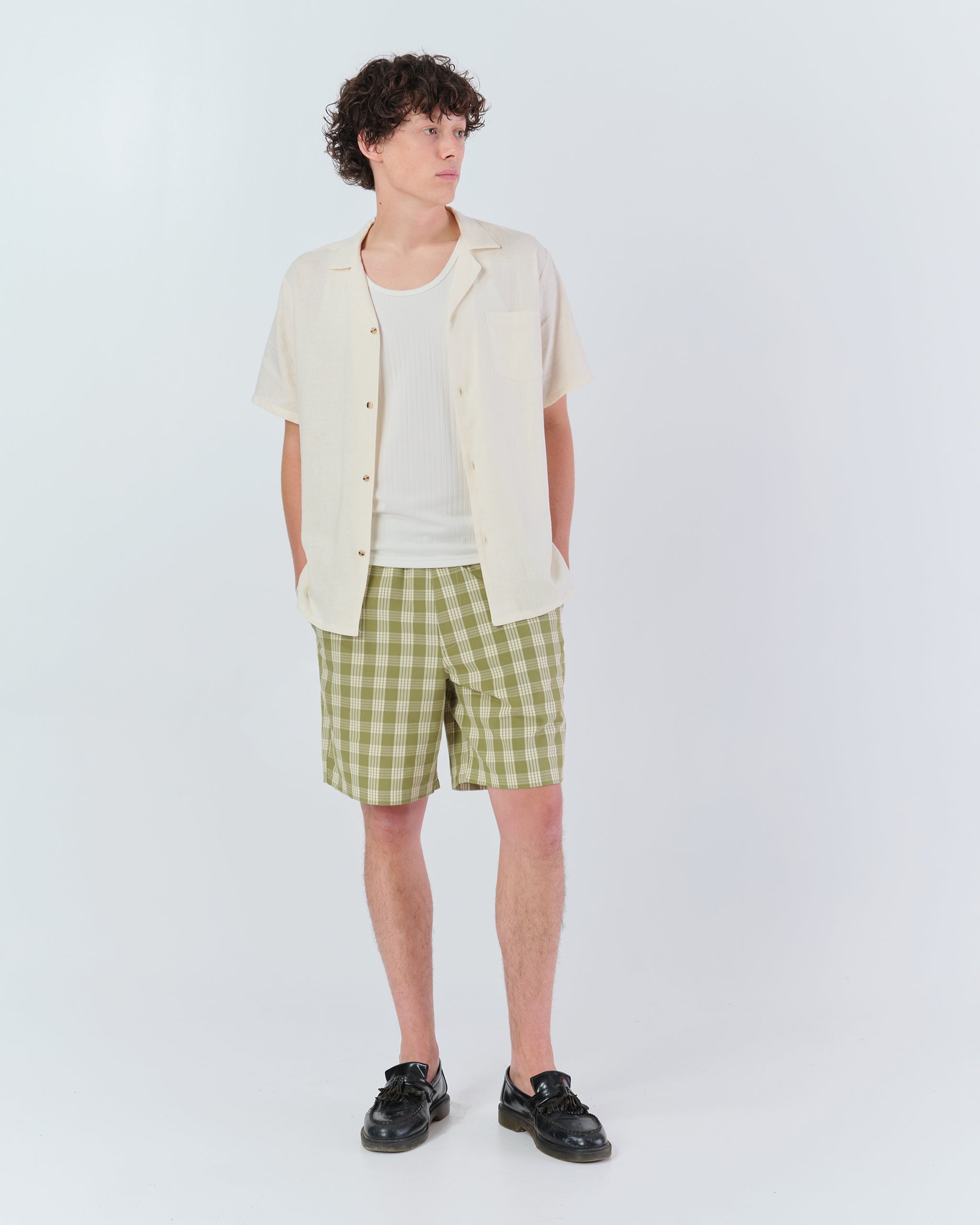 Model wearing Bather men's green check shorts