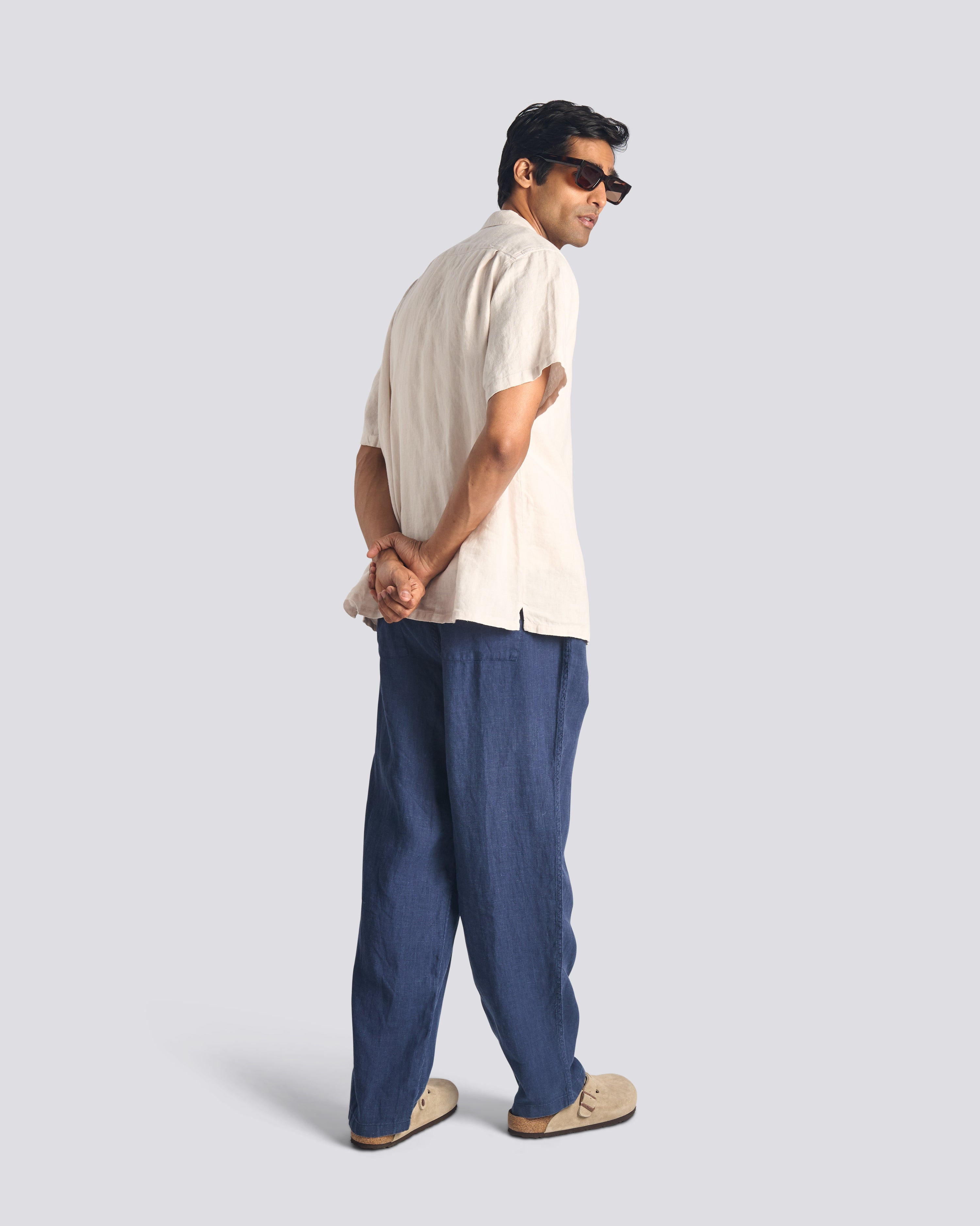 Bather men's navy linen drawstring pant worn by model on white background