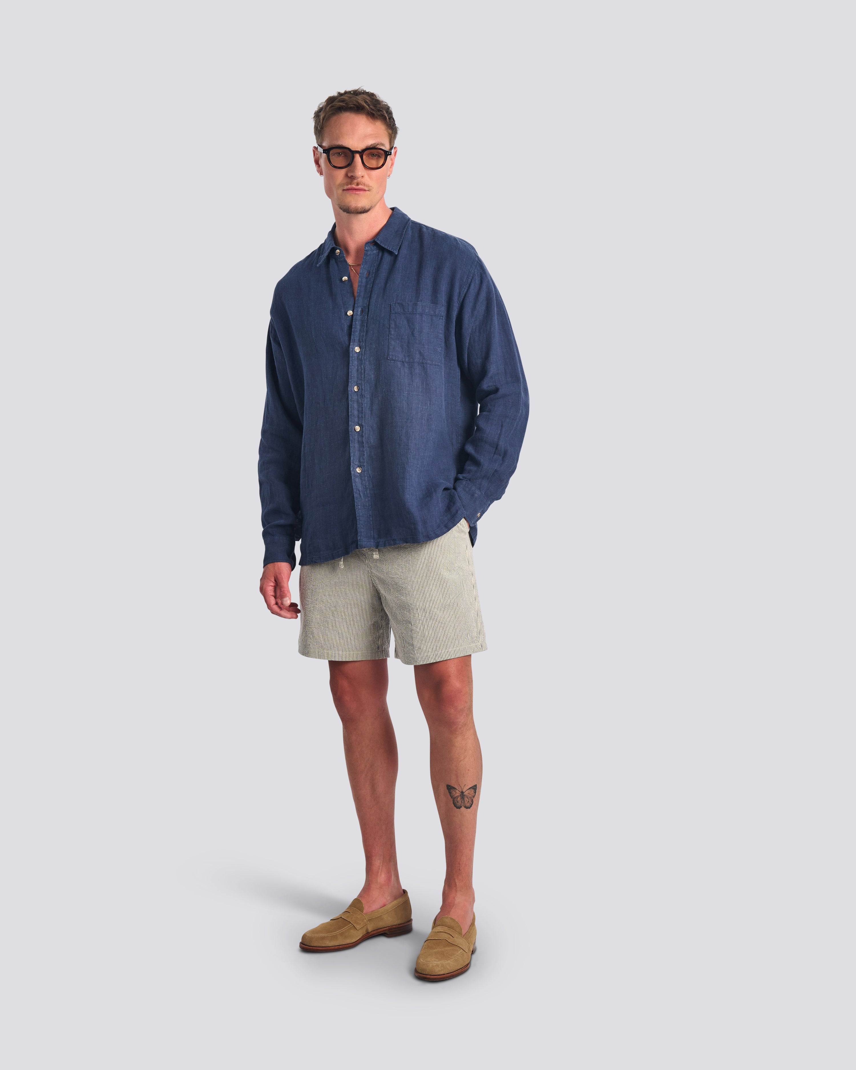 Model wearing Bather men's navy pinstripe leisure shorts