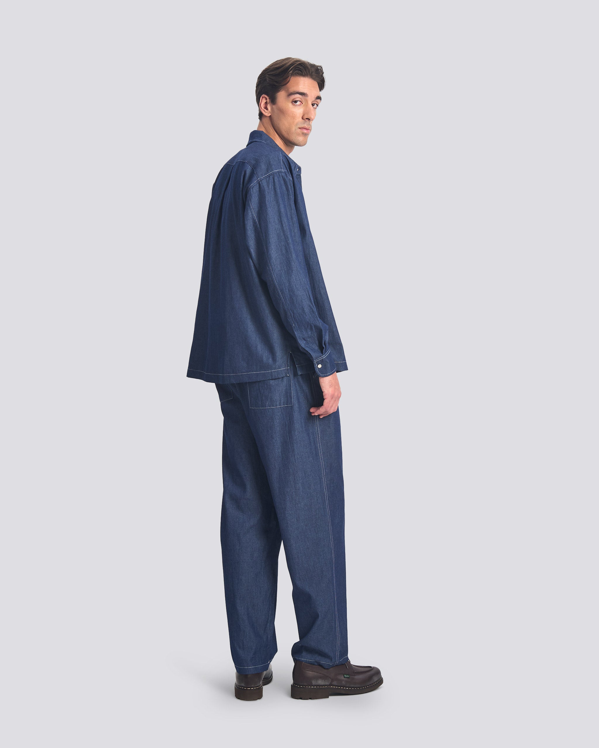 Bather men's dark wash denim leisure pant worn by model on white background