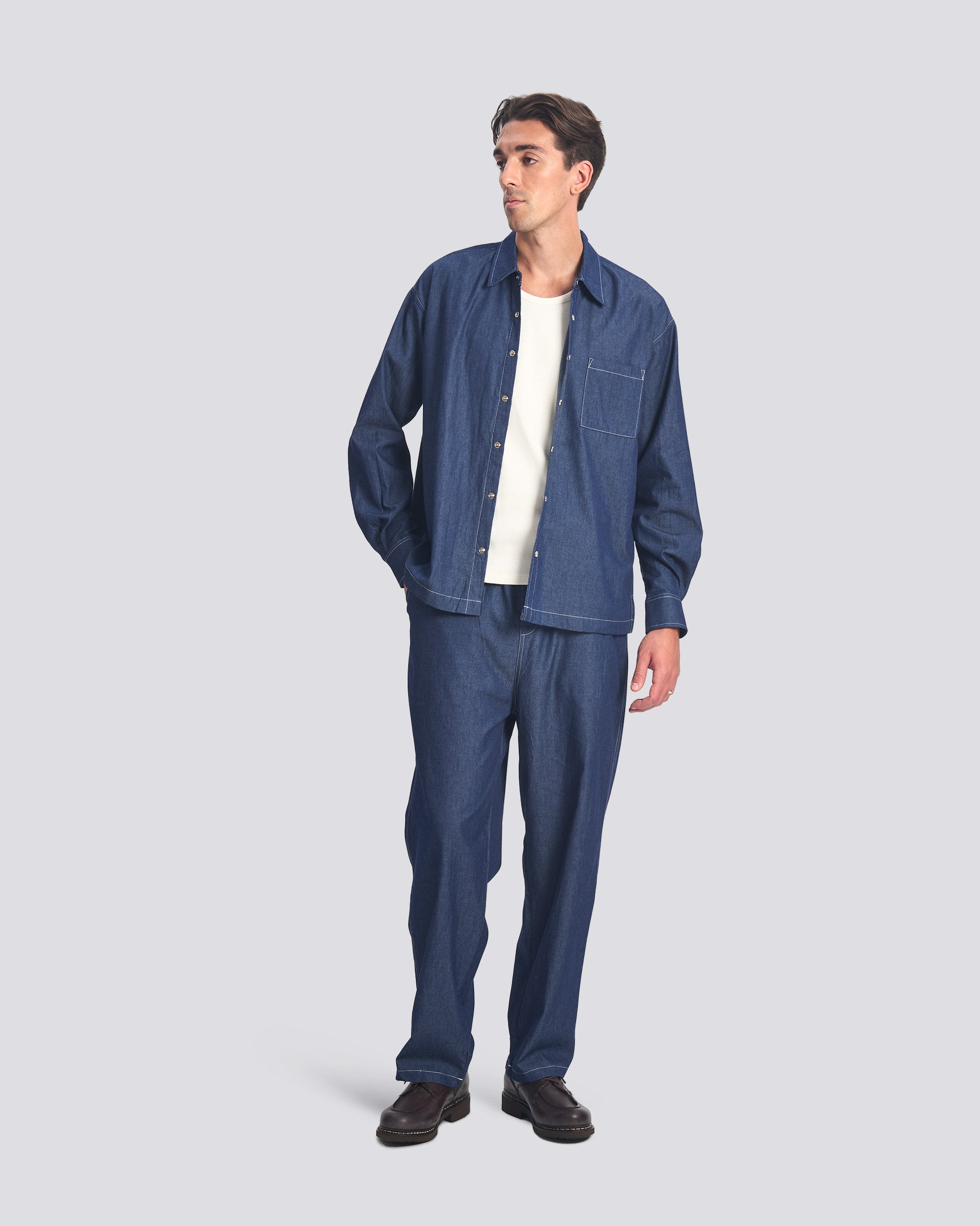 Bather men's dark wash denim leisure pant worn by model on white background