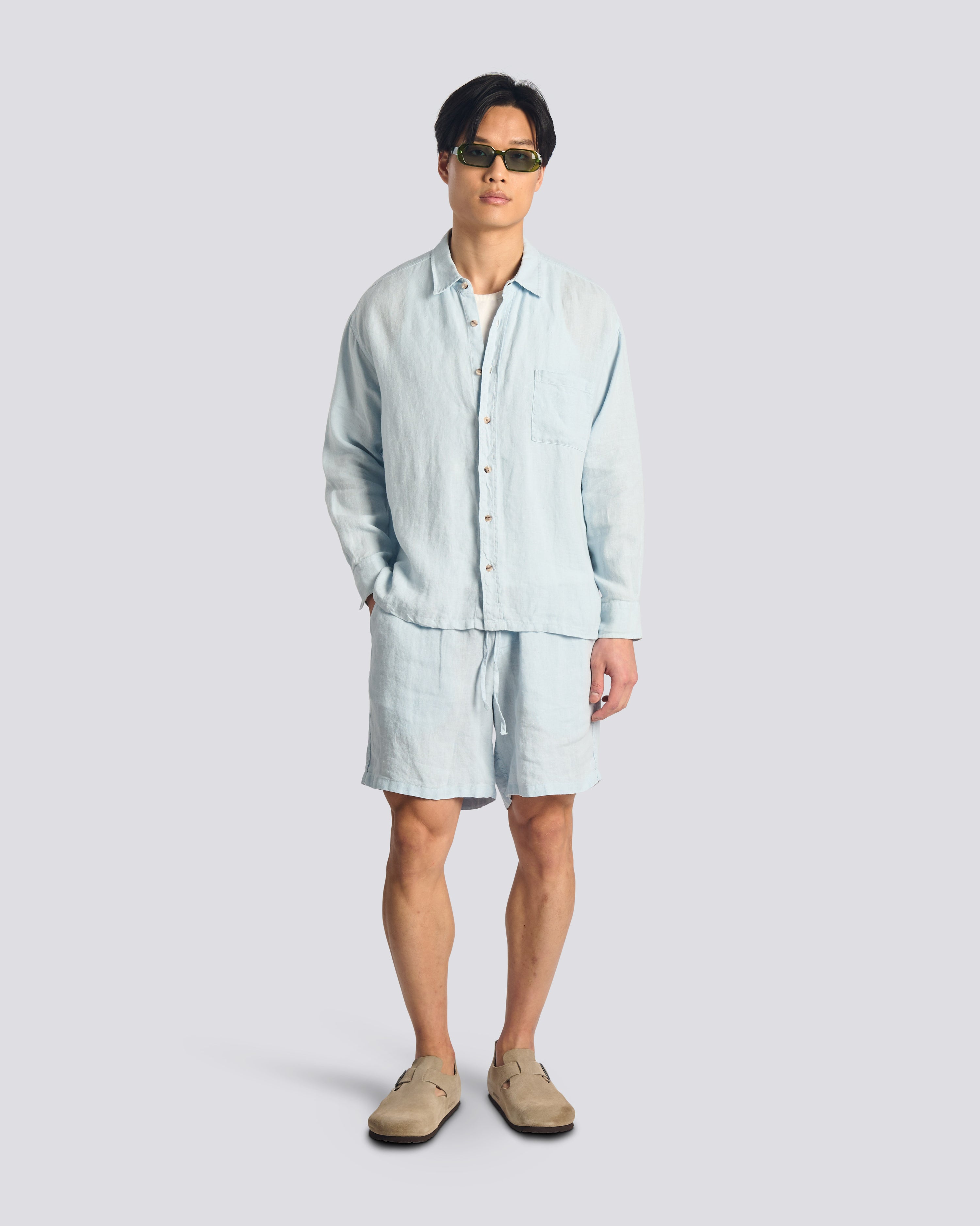 Model wearing Bather men's light blue linen drawstring shorts