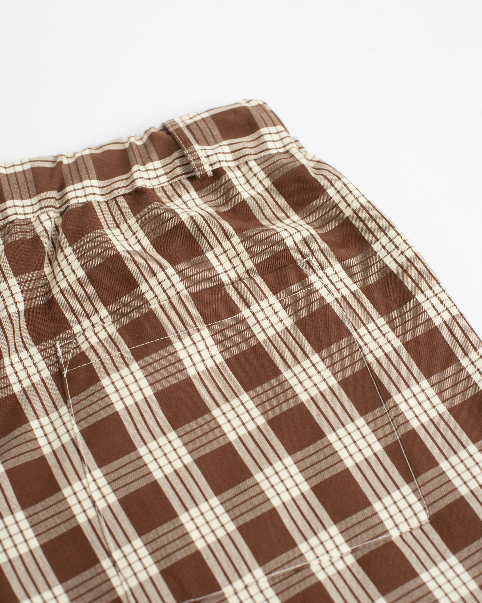 Closeup back pocket shot of Bather men's dark brown check print shorts