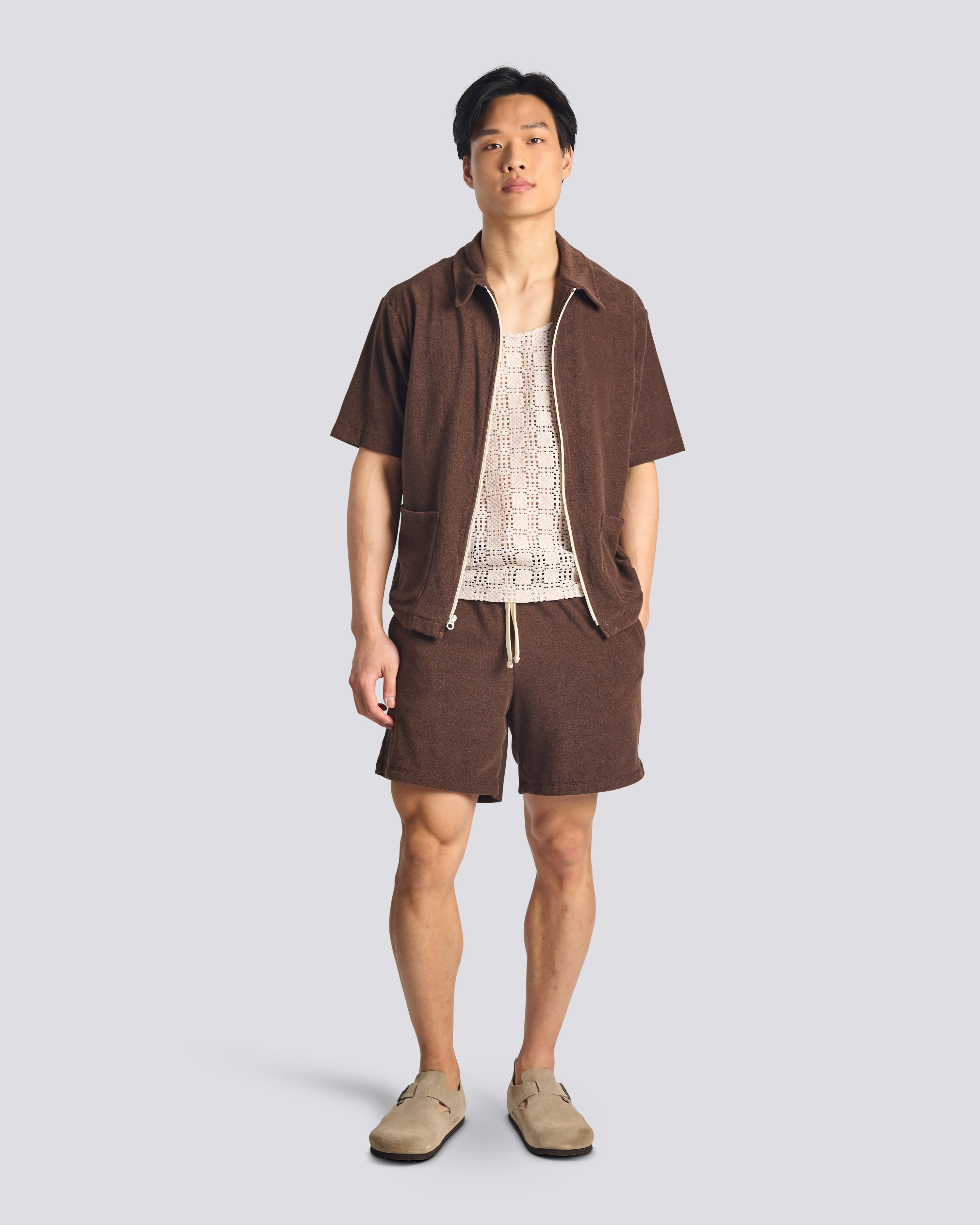 Model wearing Bather men's dark brown towel terry shorts