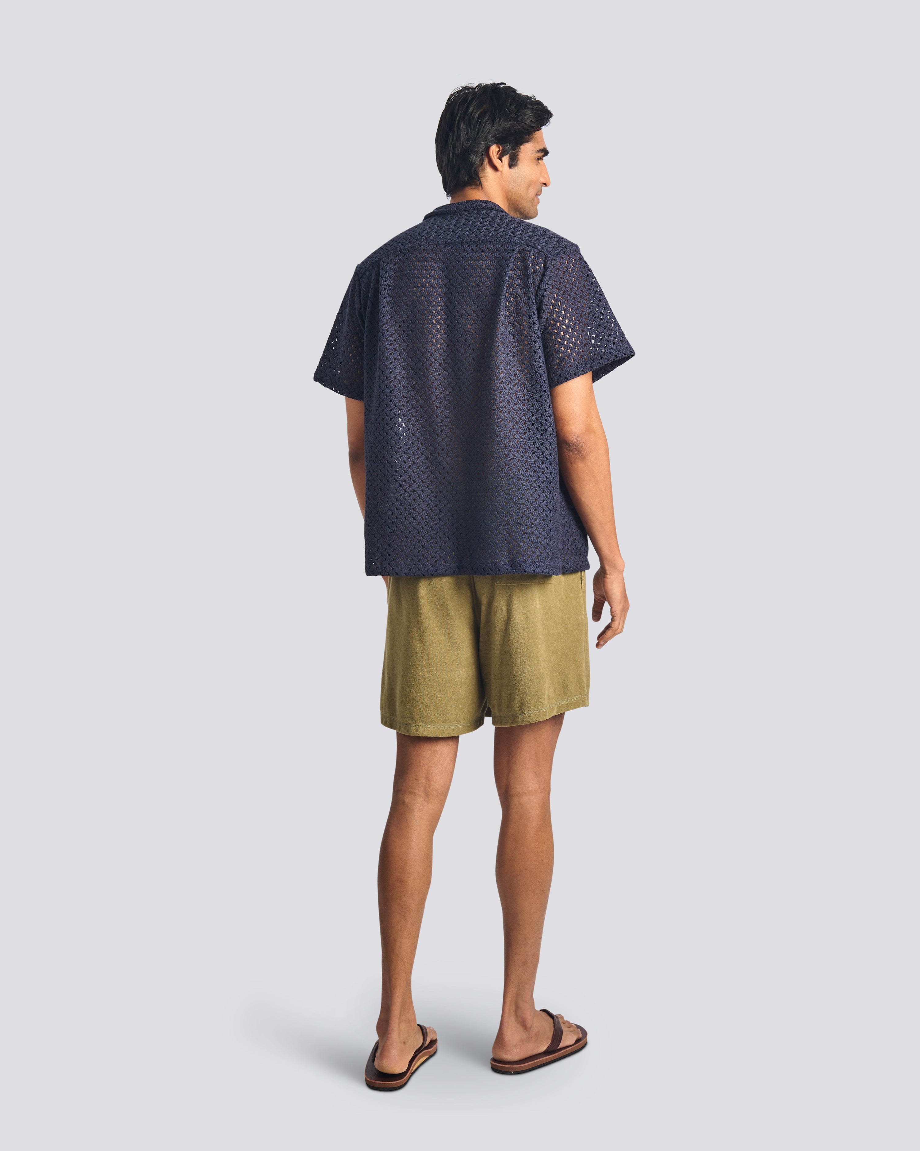 Back view of model wearing Bather men's army green towel terry shorts