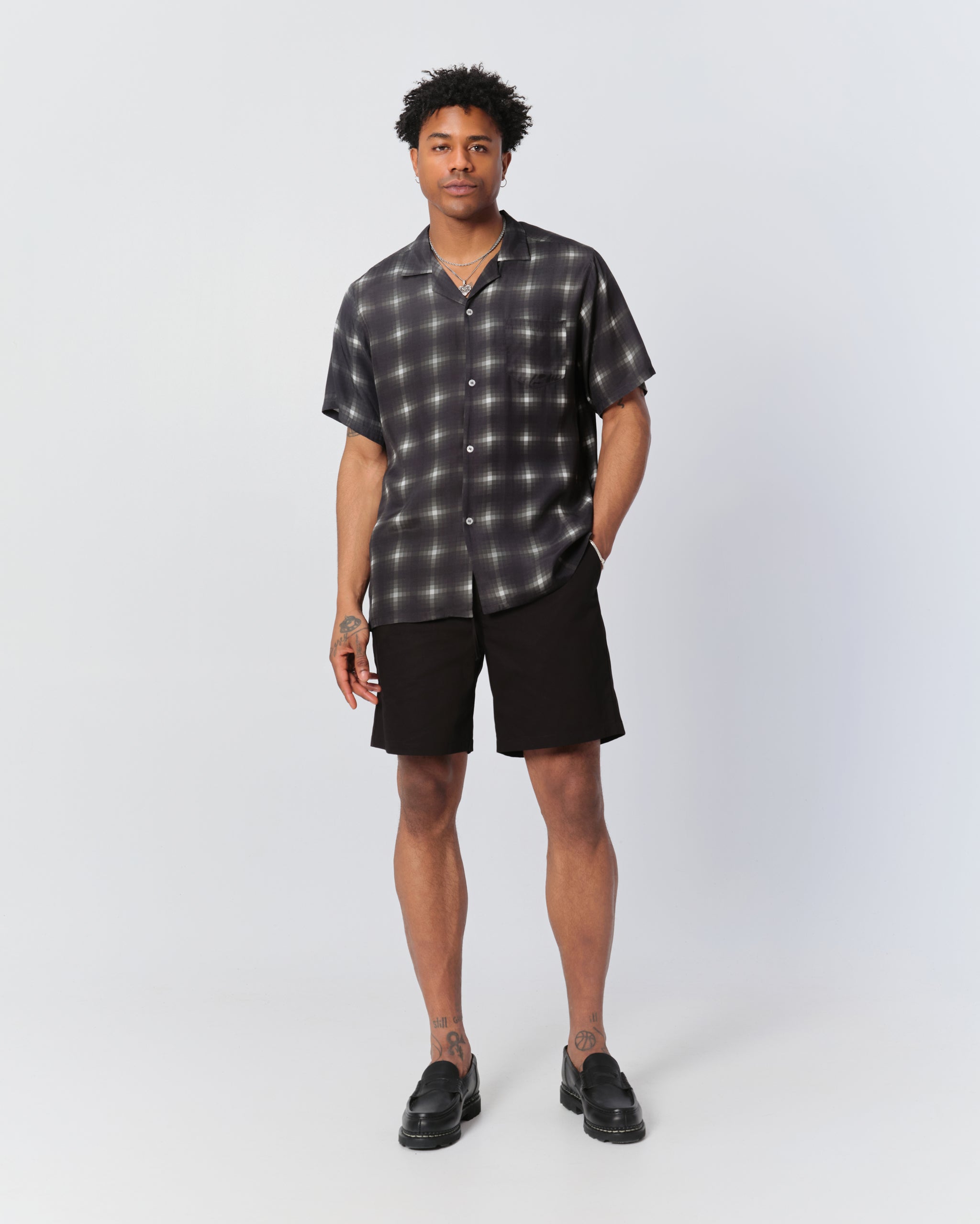 Model wearing Bather men's black herringbone shorts