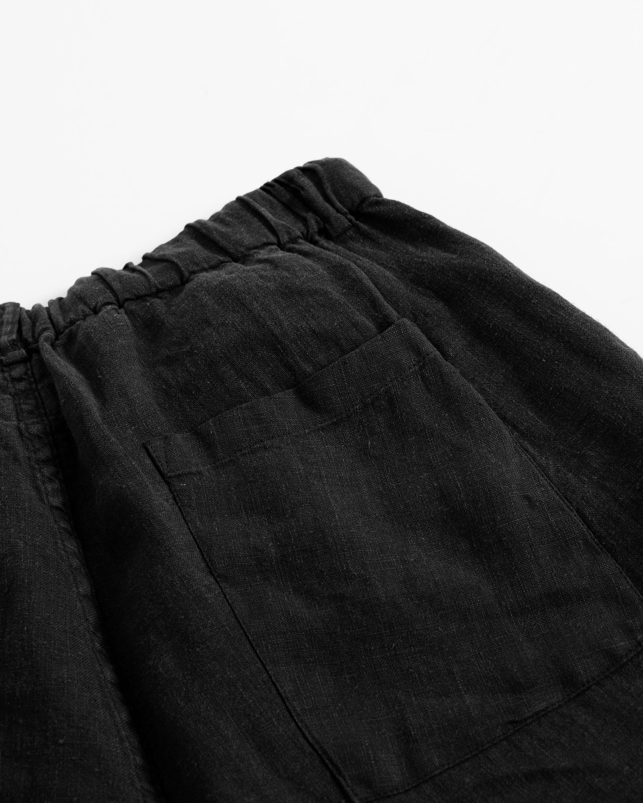 Closeup back pocket of Bather men's black linen shorts
