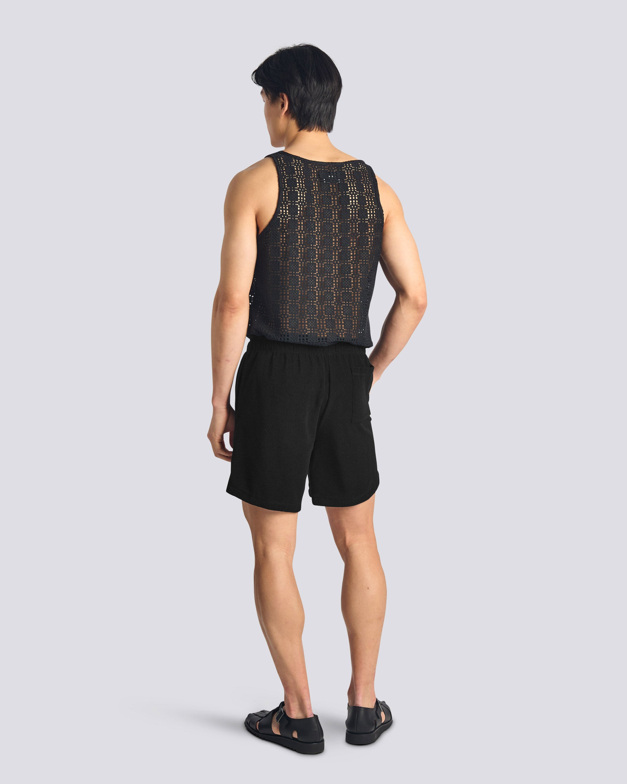 Back view of model wearing Bather men's black towel terry drawstring shorts