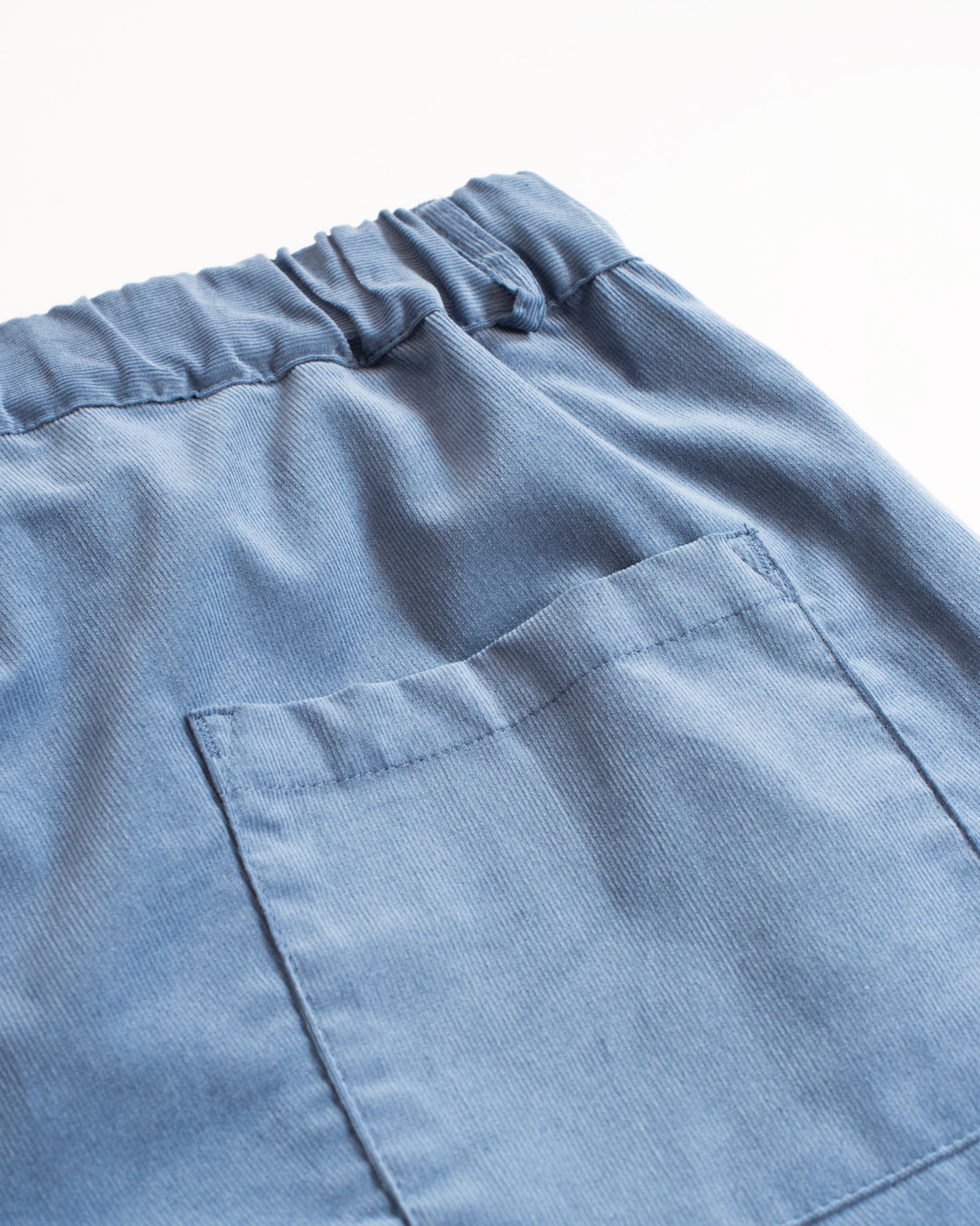 Back pocket detail of Bather men's solid blue corduroy shorts