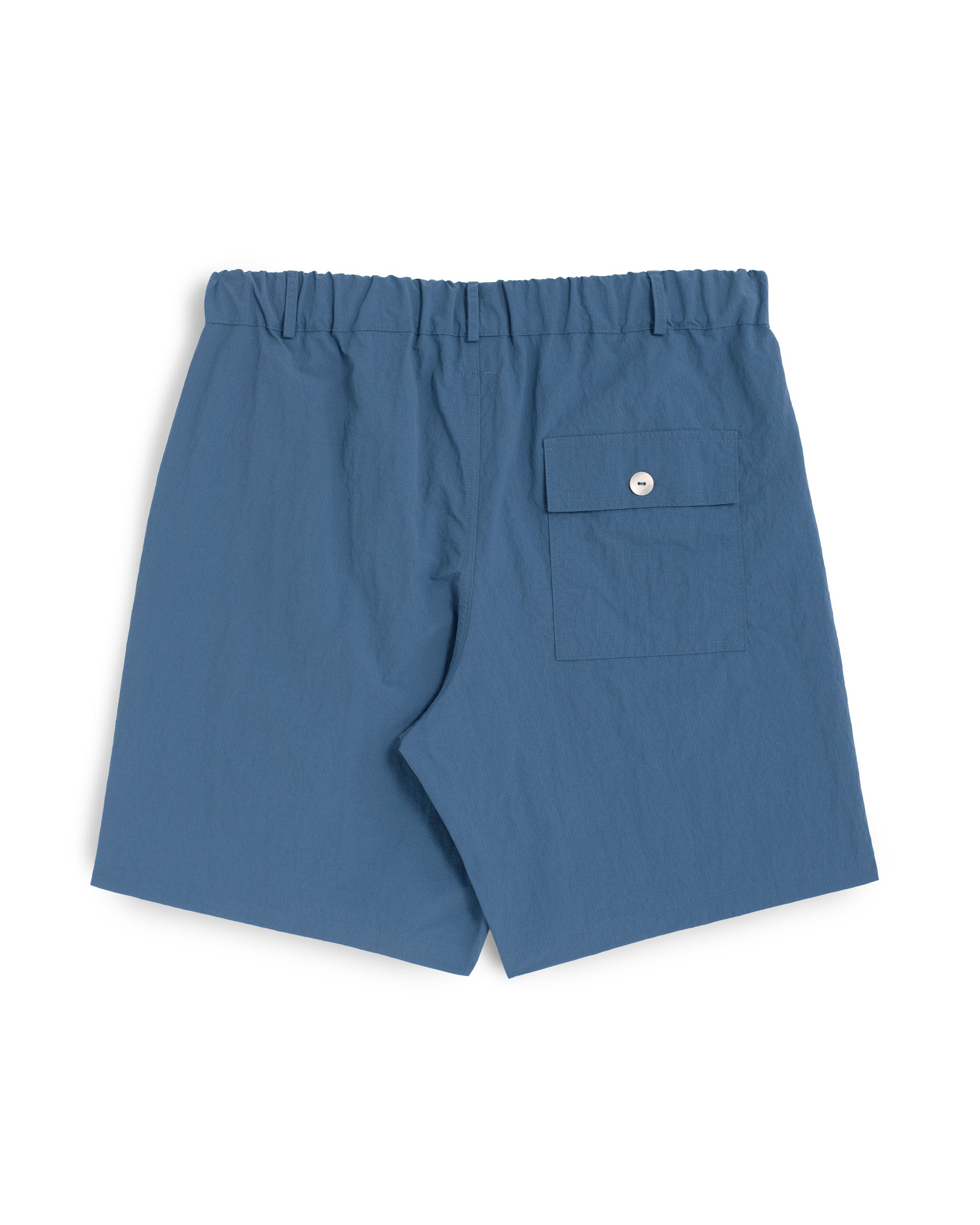 Back view of Bather men's solid blue utility shorts on a white background