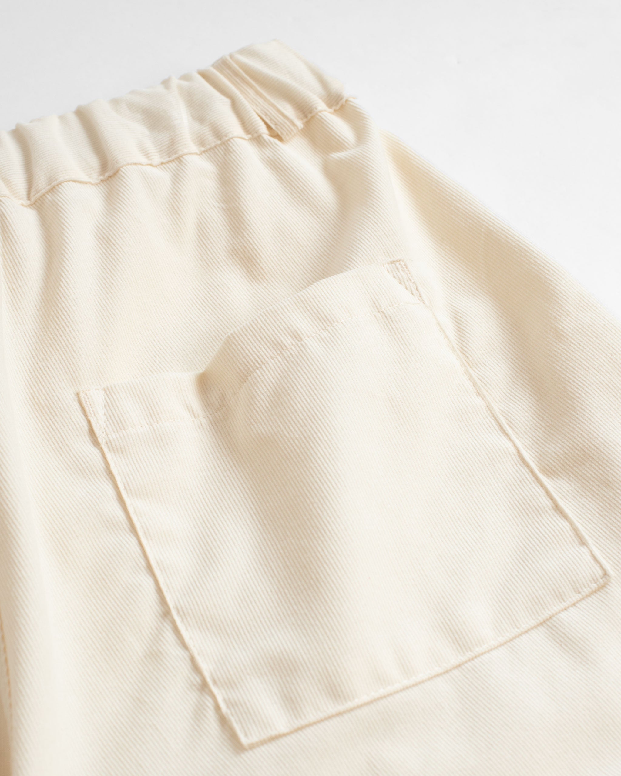 Back pocket detail of Bather men's cream corduroy shorts