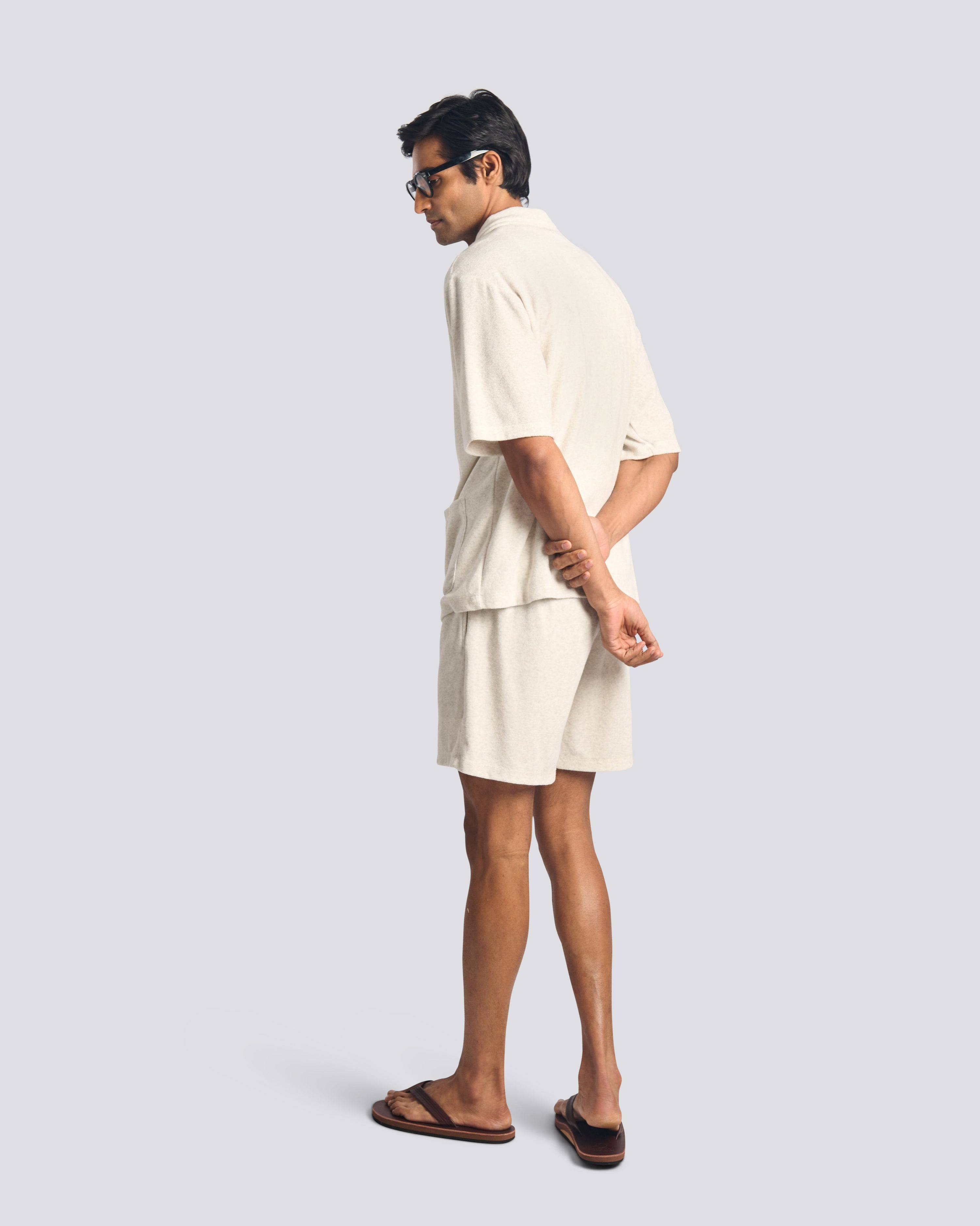 Model wearing Bather men's cream towel terry drawstring shorts