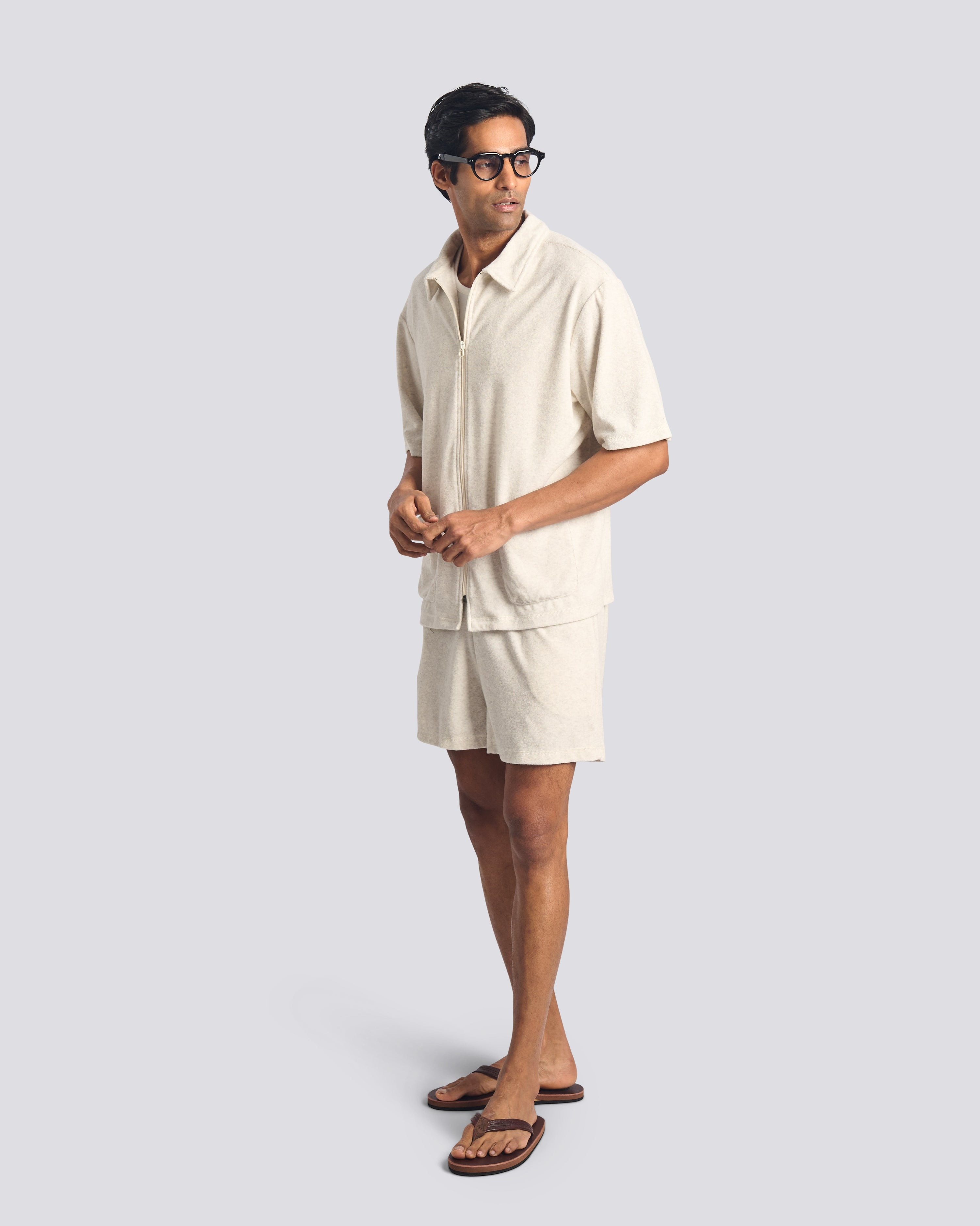 Model wearing Bather men's cream towel terry drawstring shorts