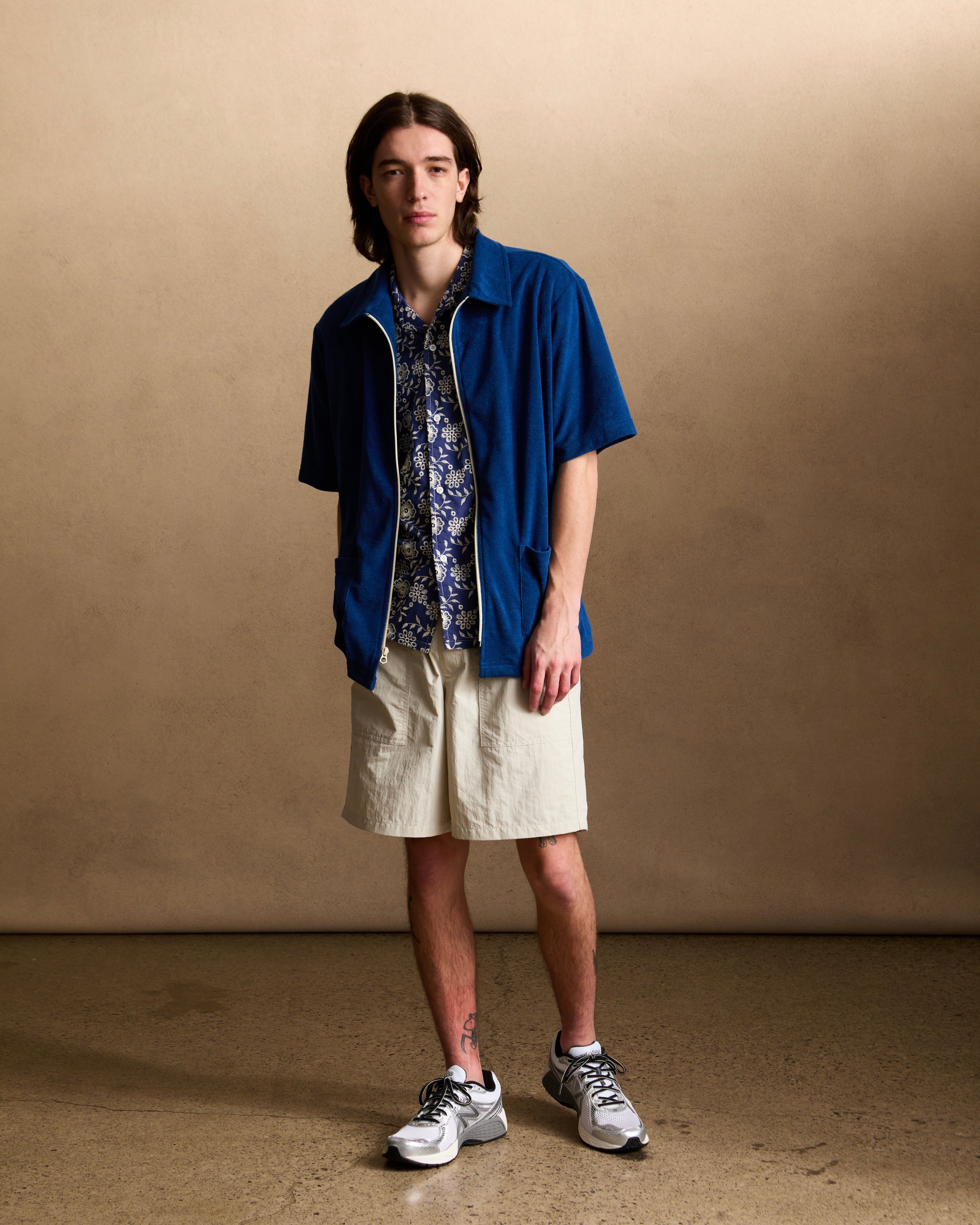 Model wearing Bather men's cream utility short