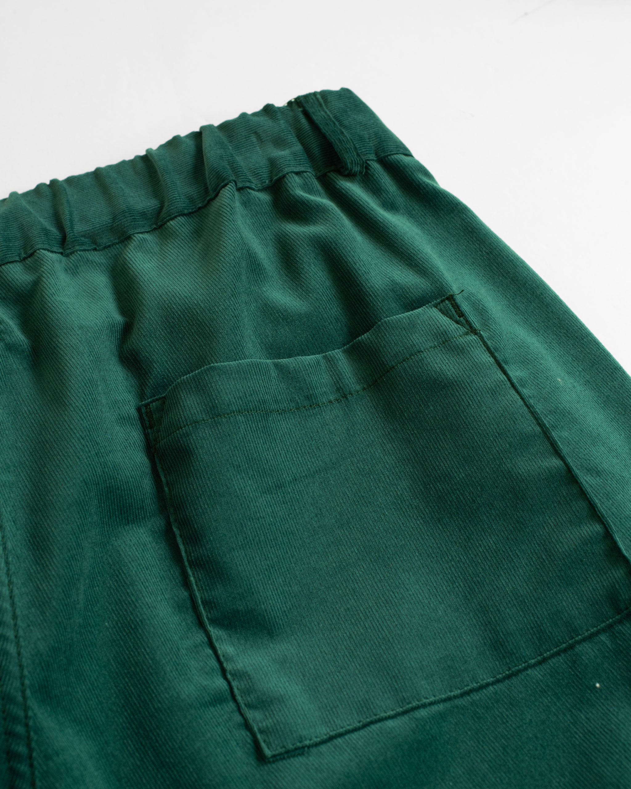 Back pocket detail of Bather men's forest green corduroy shorts