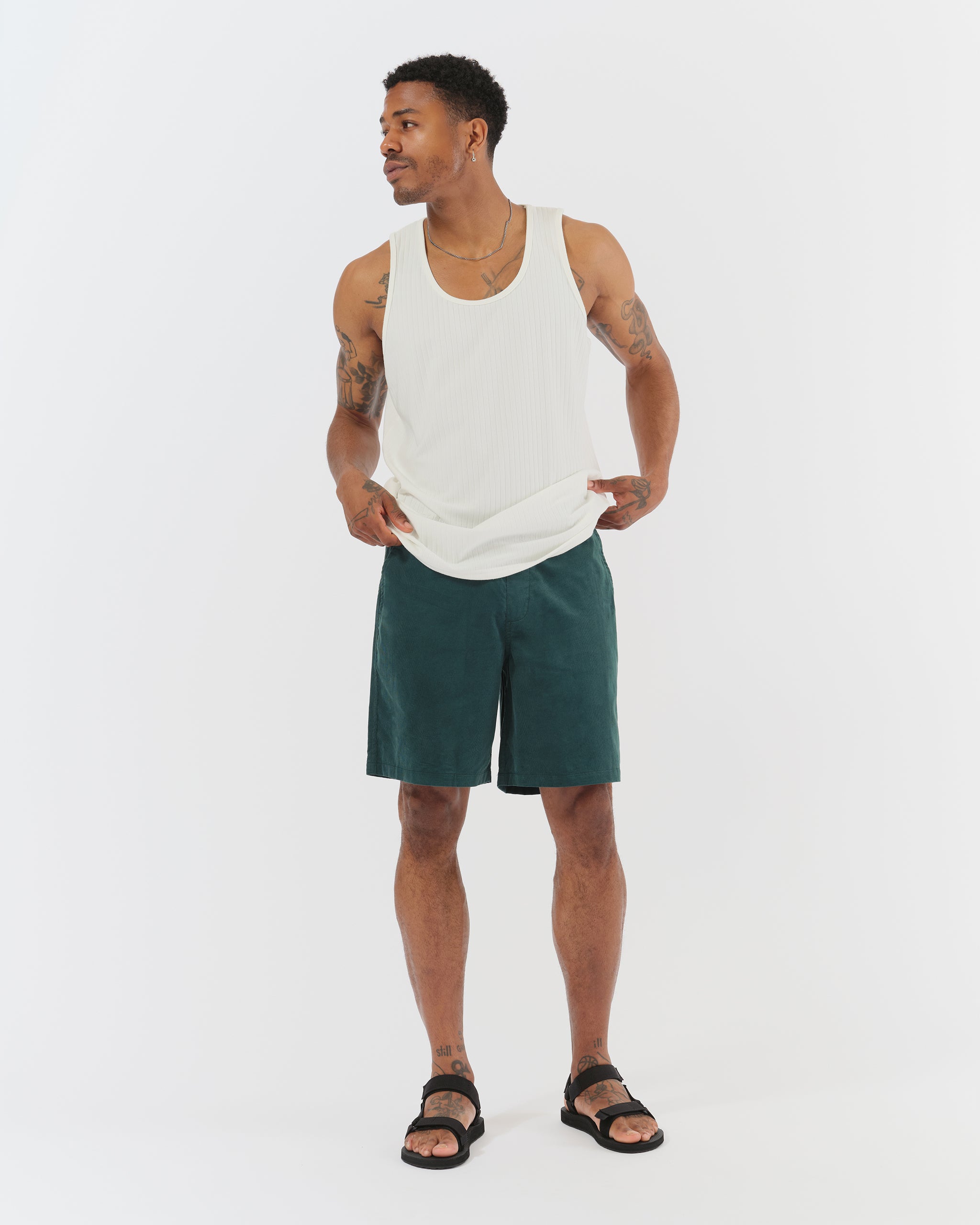 Model wearing Bather men's forest green corduroy shorts