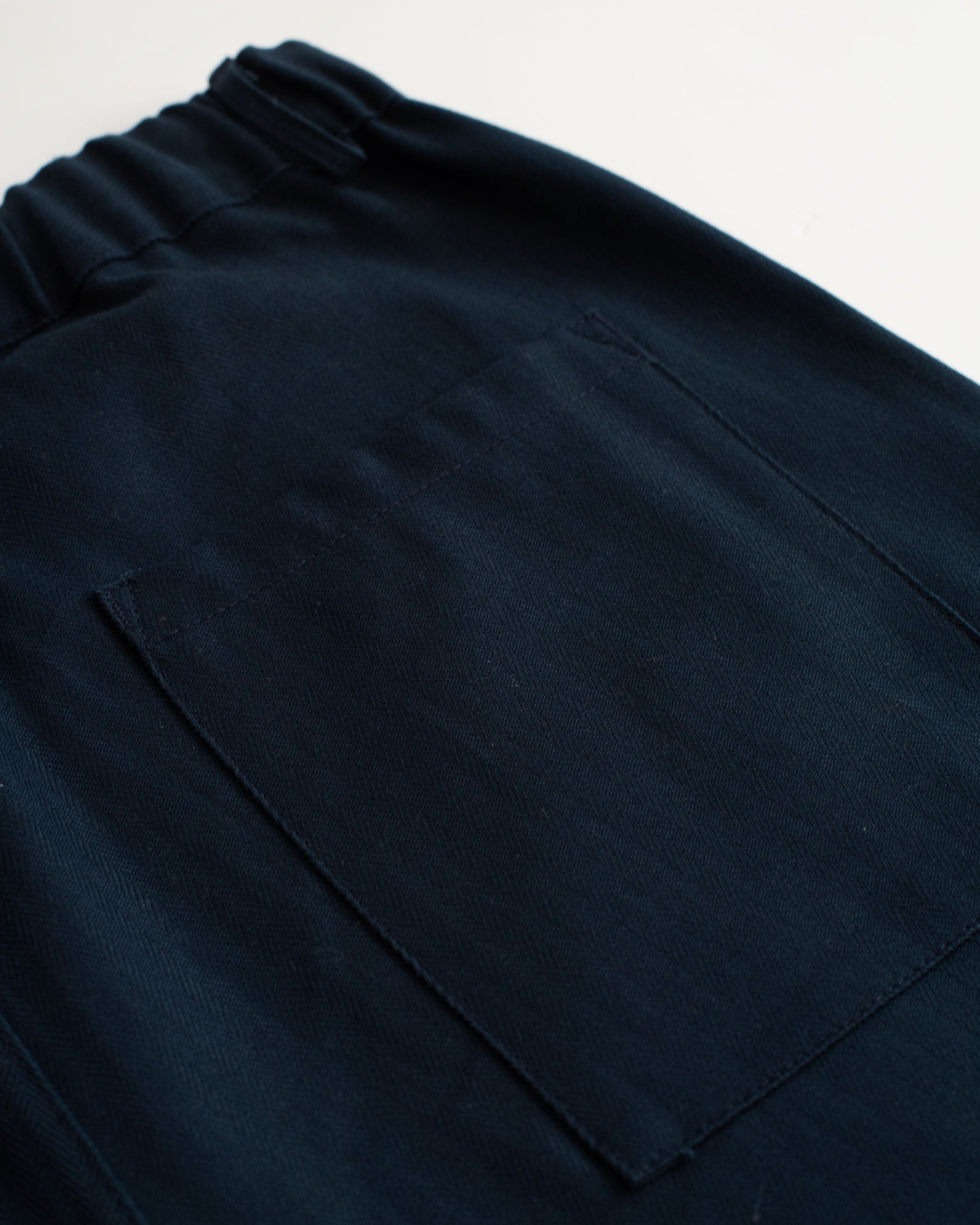Back pocket detail of the Bather men's navy herringbone leisure short