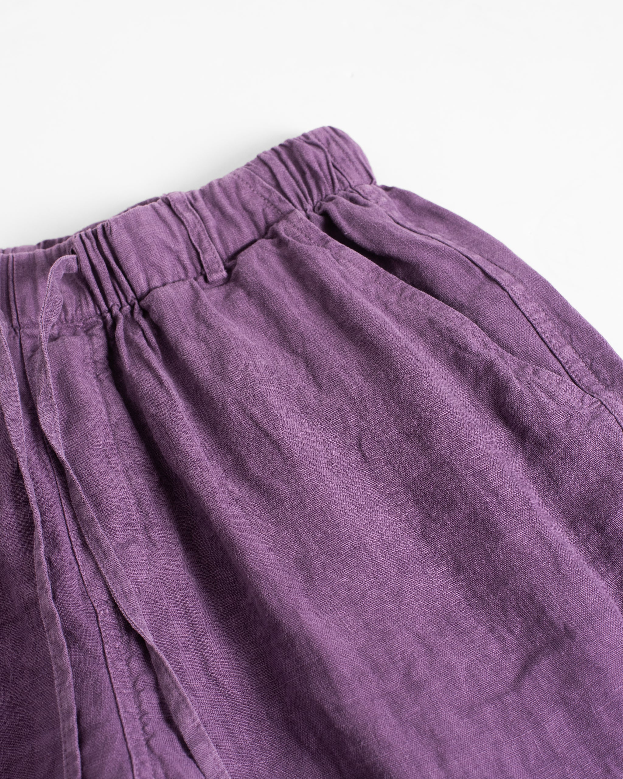 Waistband detail on Bather men's purple linen drawstring shorts