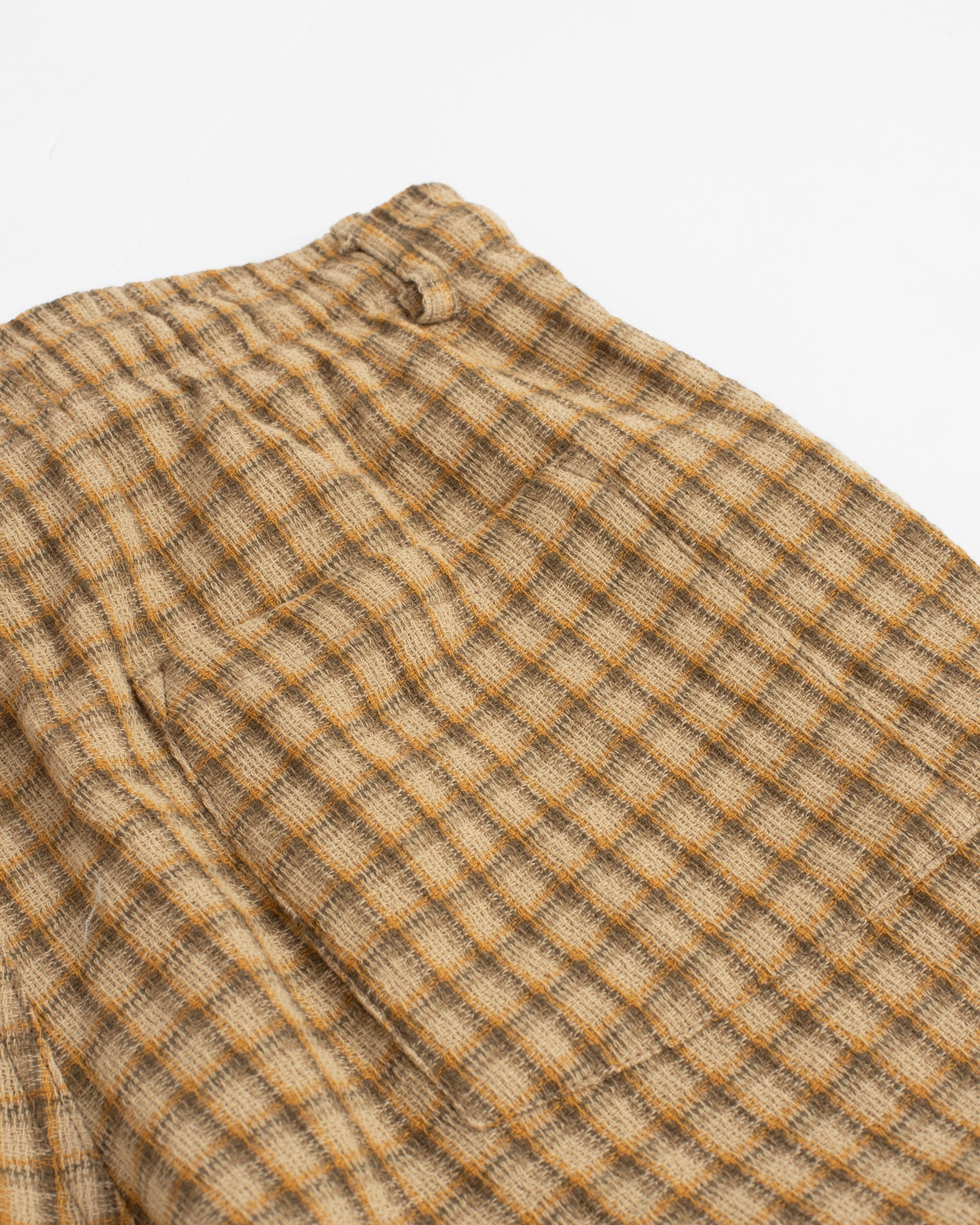 Back pocket closeup of Bather men's beige plaid drawstring shorts