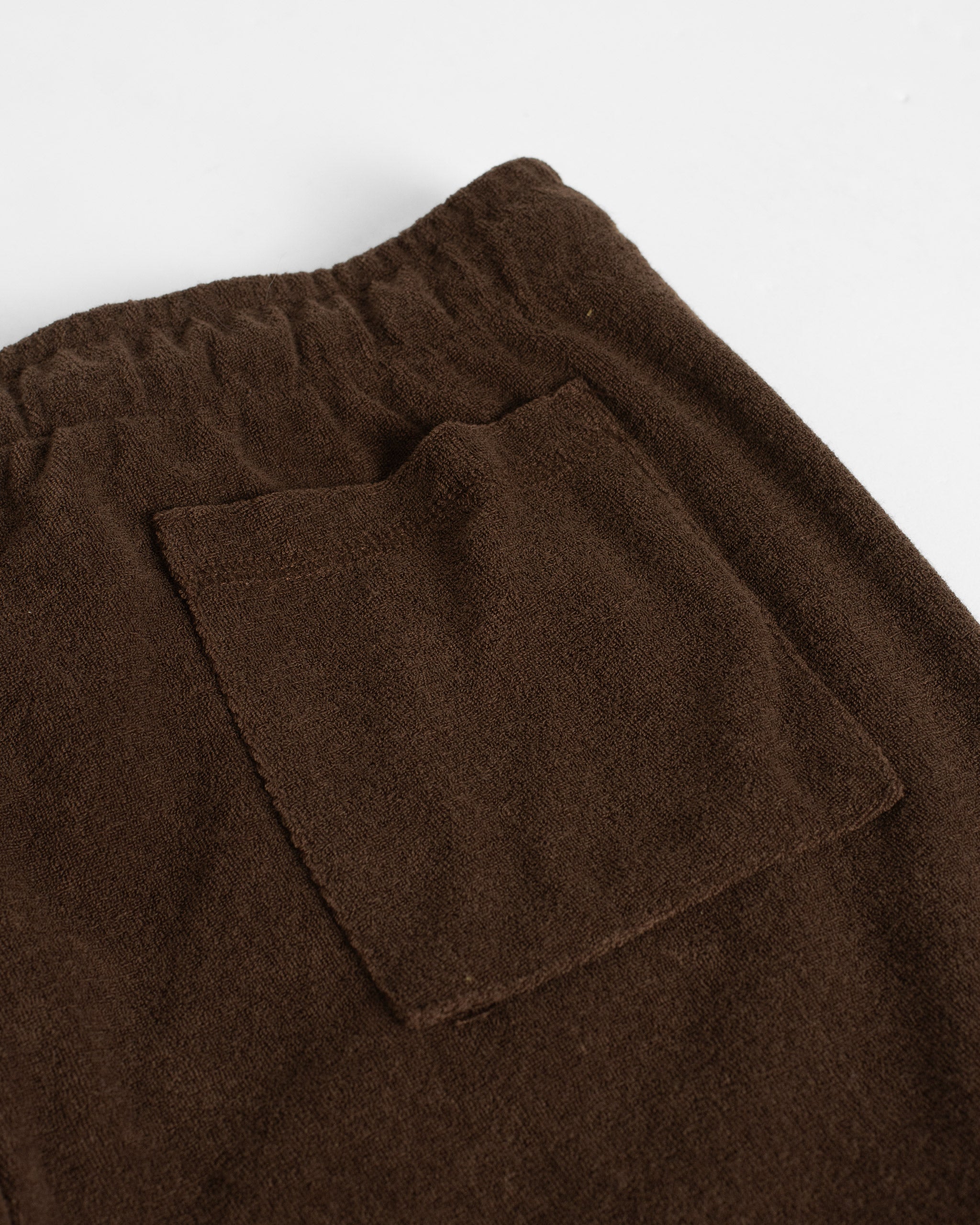 Back pocket closeup shot of Bather men's dark brown towel terry shorts