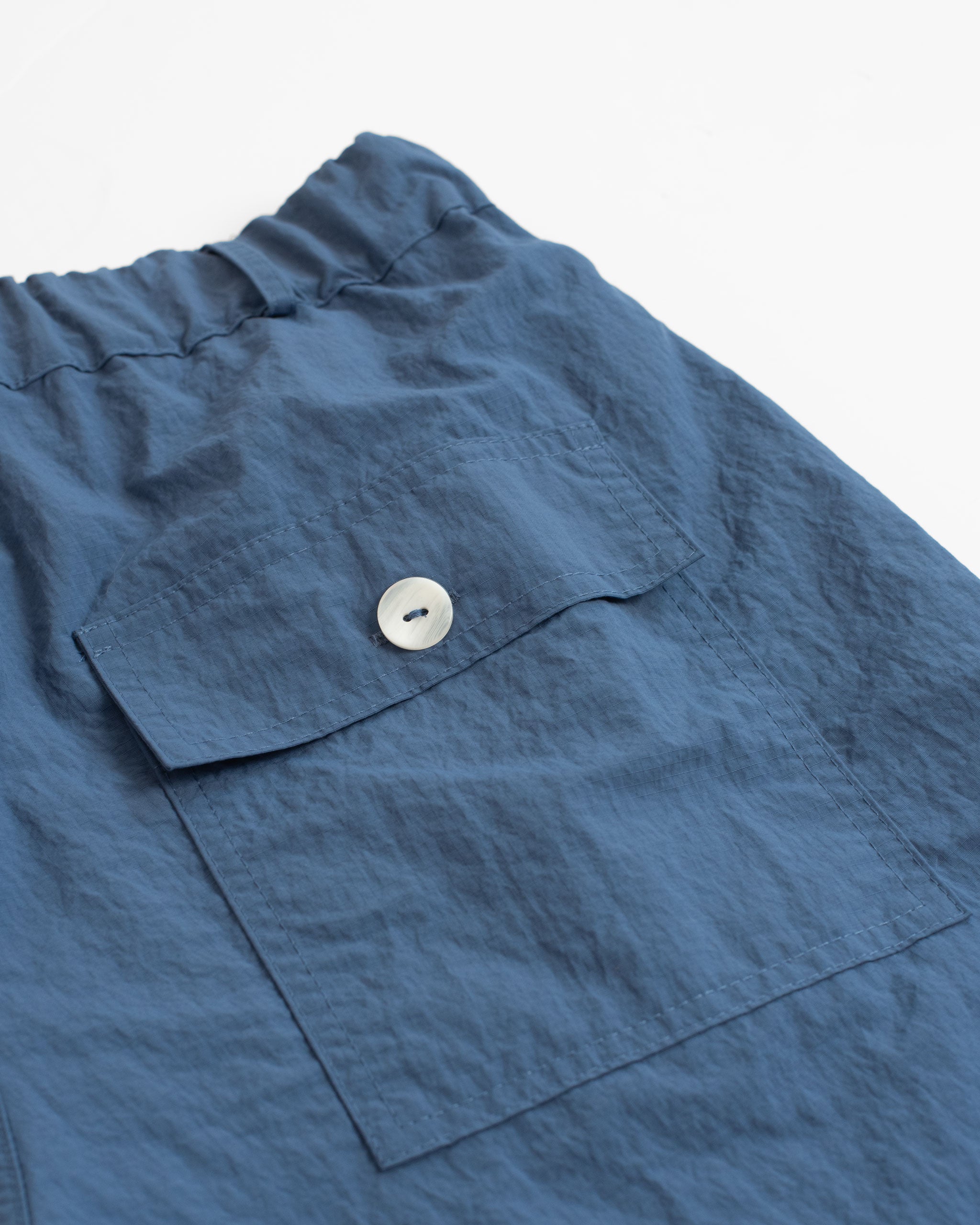 Back pocket shot of Blue utility shorts in 100% nylon