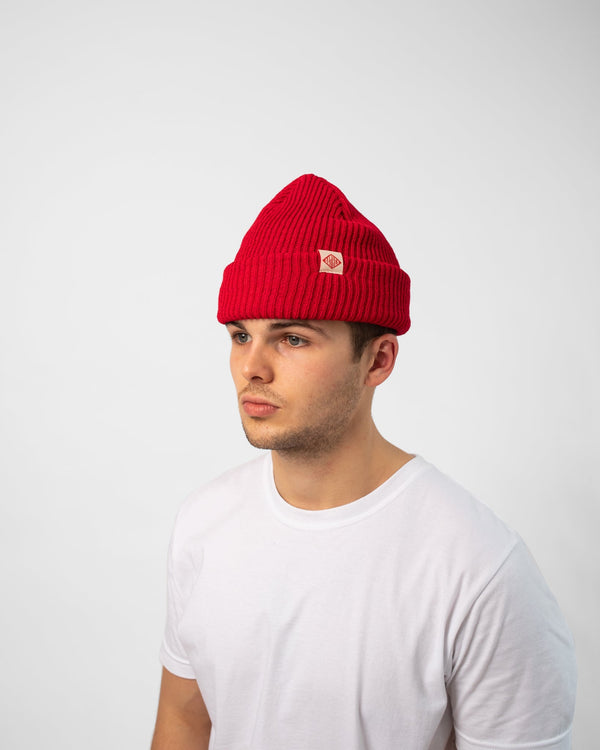 Model wearing red Bather knit beanie with white and red logo tag